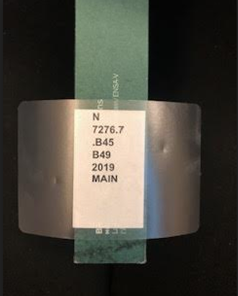 A book with the call number label applied to the spine.