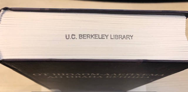 A book with UC Berkeley Library stamped on the top of the pages.